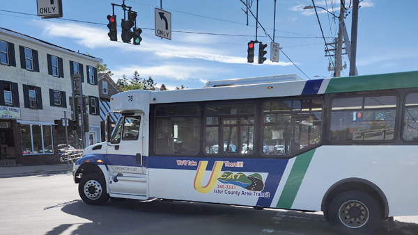 UCAT bus turns left at traffic signal in downtown New Paltz, New York.