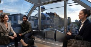 Rendering of three people traveling within Whoosh cable car.