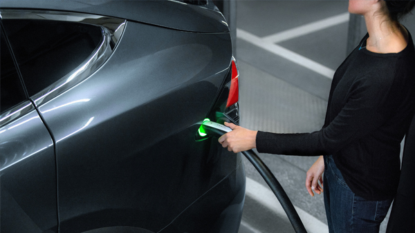 Woman charging Tesla