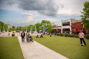 People congregate in and around Decatur Square amid open and green spaces.