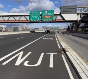 Bus Rapid Transit hard shoulder lane near MetLife Stadium with signs for Washington Avenue, Route 120, and American Dream ahead.